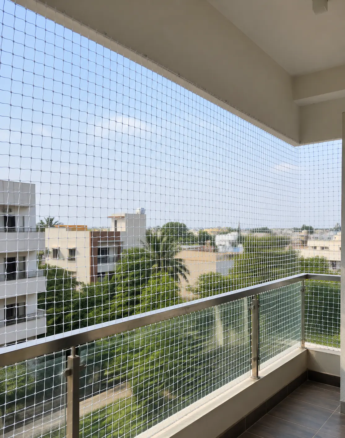 White balcony safety net fitted floor to ceiling on an apartment balcony